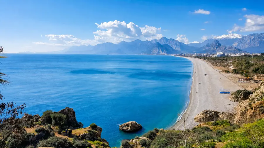 Antalya. Konyaaltı beach and snow on the Bey Mountains, the view on the drive in from the airport.