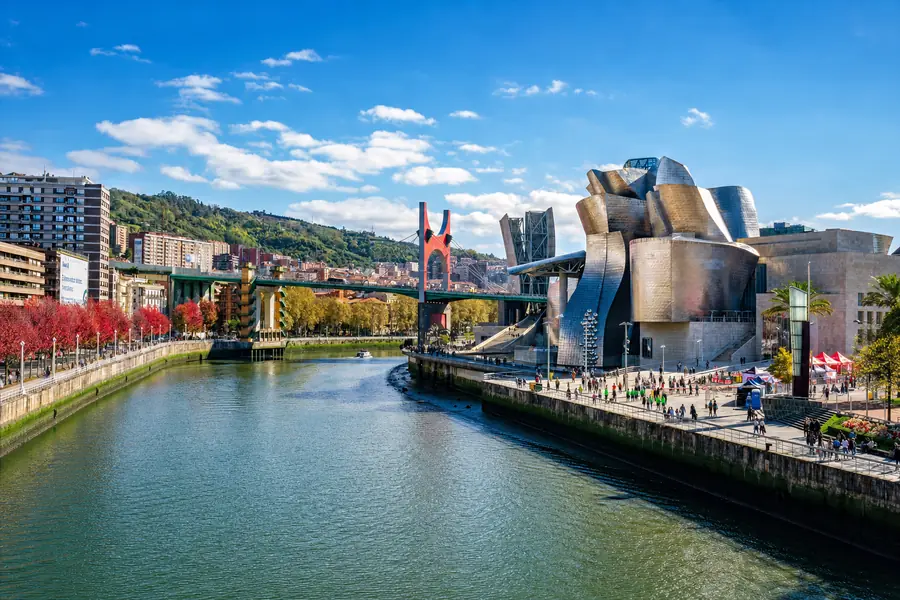Bilbao. The Guggenheim and the red La Salve bridge on the Nervión, where the trip starts and ends.